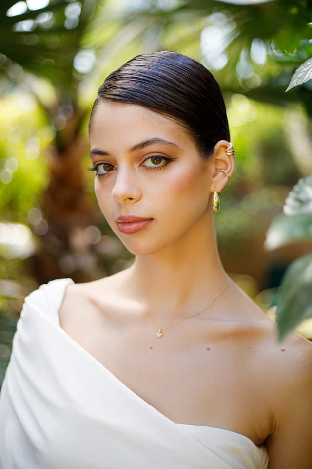 Complete bridal look: unconventional eyeliner, false lashes, and a sleek low bun. Bridal Makeup Artist Maria Gorelova in Haifa, Israel.